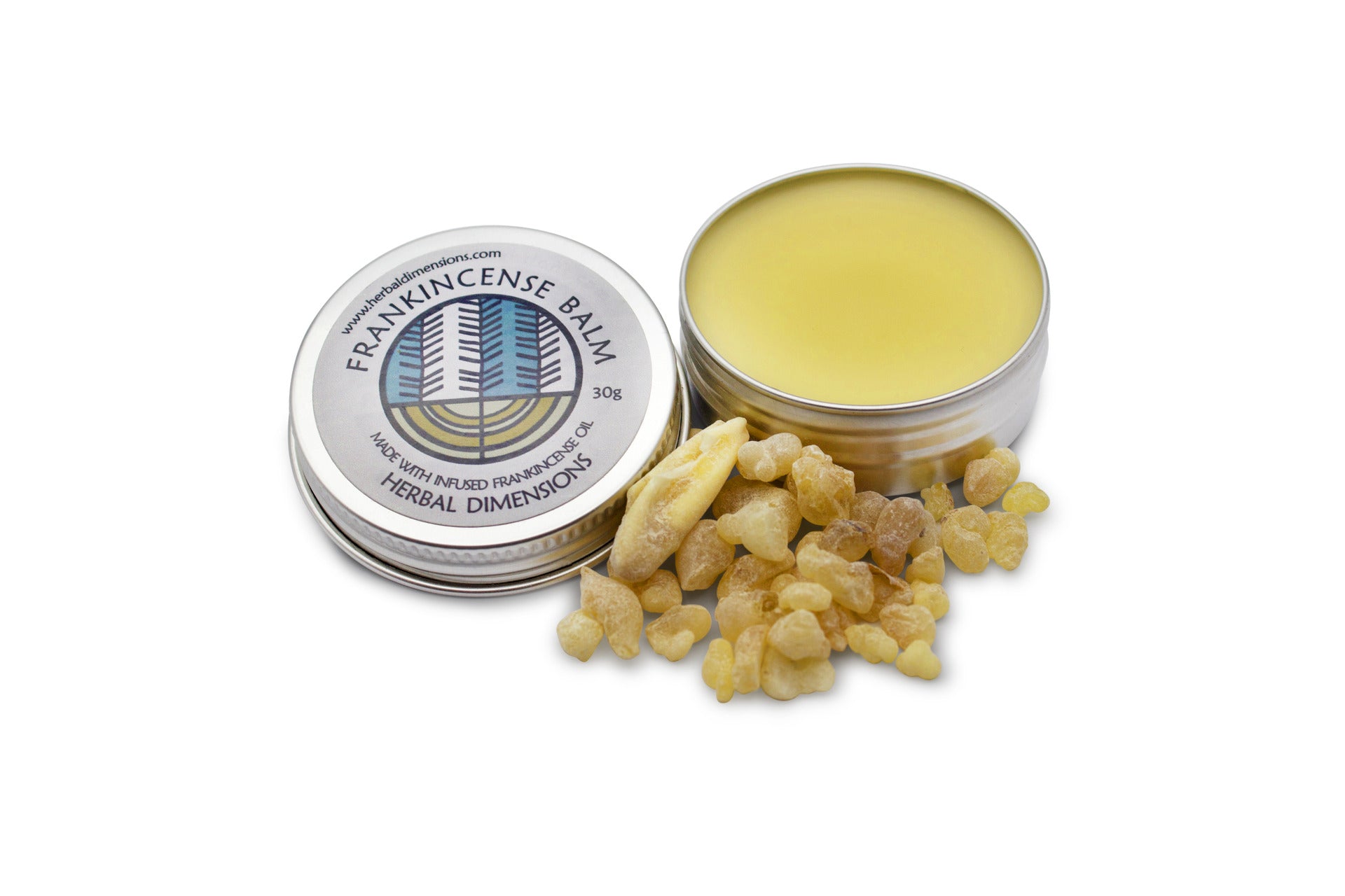 A metal pot of frankincense balm next to a pile of resin